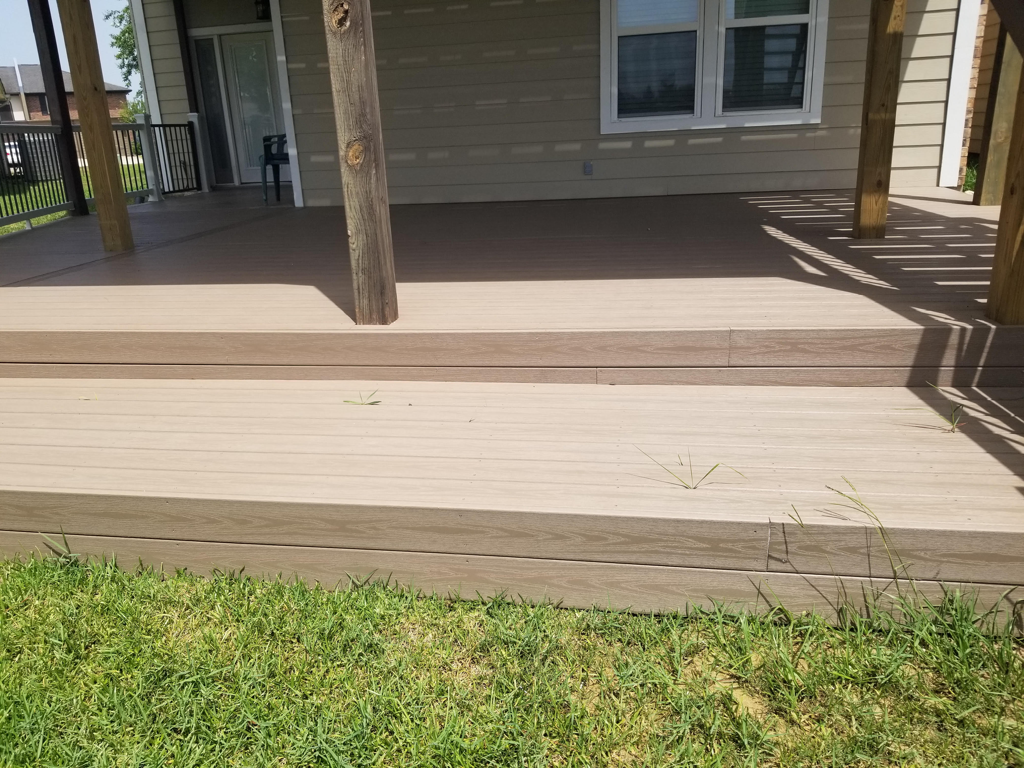 Custom covered patio addition built onto the back of a home by Cavalier Custom Decks